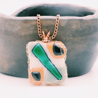 Fused glass pendant with wire wrapping green dichroic